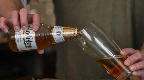 Six things that could get more expensive for Americans under Trump tariffs Getty Images A barman pours a bottle of Modelo beer into a glass