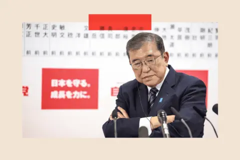 How Japan's far right was supercharged by Trump and tourists EPA Shigeru Ishiba folds his arms and speaks to the media via multiple microphones