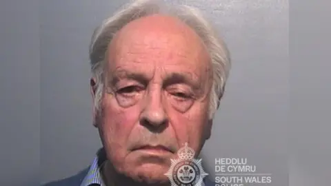 Police investigate sex abuse claims against men linked to Church South Wales Police A mugshot of Anthony Pierce who has white hair and is wearing a striped blue shirt and blue sweatshirt and is looking directly at the camera with a neutral expression