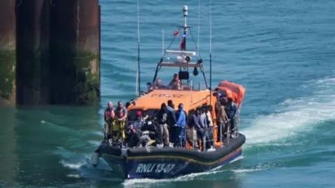 UK-France migrant deal 'robust' against legal challenges, Yvette Cooper says PA group of people thought to be migrants are brought in to Dover, Kent, onboard an RNLI Lifeboat