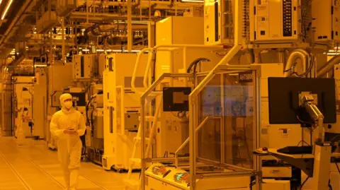 How Trump's tariff chaos is reshaping Asia's businesses Getty Images A staff member in hazesuit walks in the cleanroom of a semiconductor manufacturing facility at GlobalFoundries in Singapore on September 12, 2023. He is surrounded by large machines that make chips.