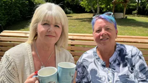 'I need someone to be punished' Nichola Arch and Wendy Buffrey sit on a bench in a sunny garden with two cups of tea