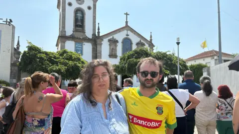 Diogo Jota and André Silva's funeral held in Portugal Sofia Ferreira Santos/BBC Rafaela and Fábio standing next to each other in front of a white church