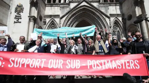 Post Office scandal had 'disastrous' impact on victims, report says Getty Images A group of sub-postmasters outside a court