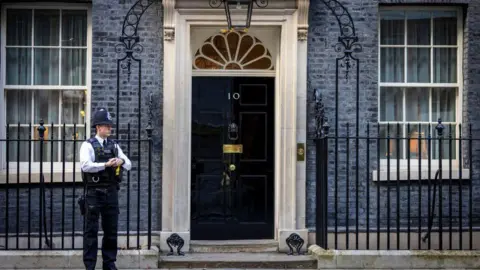 Monzo fined for giving account to fake 10 Downing St address Getty Images Police officer stands outside 10 Downing Street