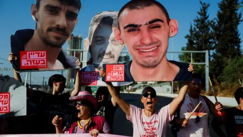 Mediators await Israeli response to new Gaza ceasefire proposal Reuters People hold photos of Israeli hostages and banners during a demonstration demanding an end to the Gaza war and the release of all the hostages held by Hamas, in Tel Aviv, Israel (19 August 2025)