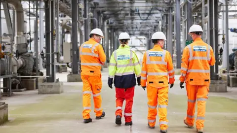 UK bioethanol industry faces collapse after government rejects rescue Vivergo Four Vivergo workers wearing hi-viz outfits walking in front of machinery at the bioethanol plant in Hull