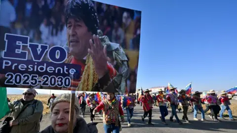 Bolivia set to elect first non-left wing president in two decades AFP via Getty Images Supporters holding a banner of Bolivian former President Evo Morales in a march.