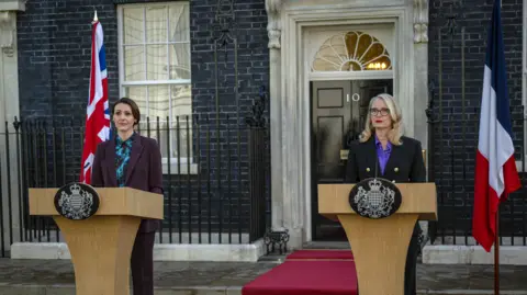 'Playing the Prime Minister 'changes your perception' of politics' says Suranne Jones Netflix Suranne Jones and Julie Delpy in character standing outside no10 downing street in front of lecterns