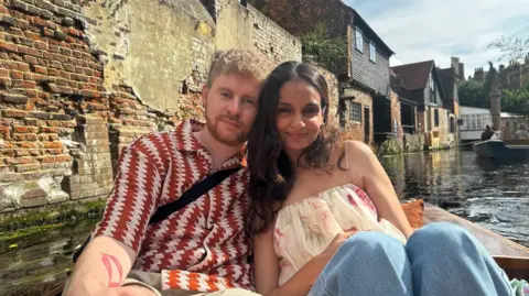 Sonic boom heard after RAF scrambled to incident Conor Kehoe Conor Kehoe and Manisha Dev are sitting in a punt on a river smiling at the camera. He has wavy fair hair, a beard and moustache and is wearing a red and white patterned shirt. She has long, wavy dark hair and is wearing a floral top and jeans