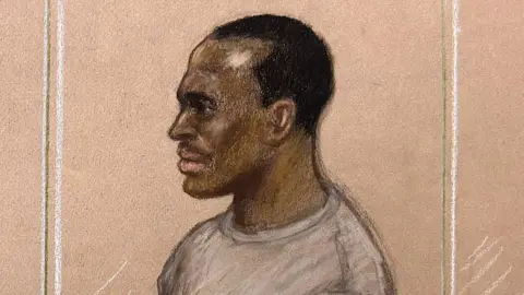 'I am not a wild animal' Julia Quenzler/BBC A court sketch of Hadush Kebatu standing in the dock at court. He is wearing a grey sweater and has short black hair.