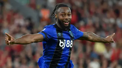 Liverpool man held over Antoine Semenyo racist abuse report bailed Reuters Semenyo celebrating after scoring for Bournemouth. He had short dreadlocked hair and a dark brown beard. He was wearing his dark blue and black Bournemouth away kit.