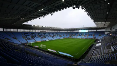 Coventry City Football Club purchases CBS Arena PA Media A general view of the stadium with blue tiered seating and a green football pitch