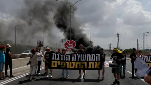 UN demands justice over Israeli double strike that killed 20 EPA Protesters next to burning tires on the main road at Petah Tikva, Israel
