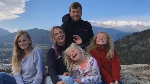 Lives torn apart by fatal crashes on the A9, Scotland's longest road Chris Strong The Bastion-Strong family are pictured on a walking trip and there are mountains and forests in the background. Chris is smiling as Katie and the three girls are laughing.