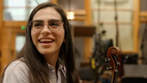 The violinist about to play 10 nights at Wembley with Coldplay BBC Pathrycia Mendonça smiles while holding her violin