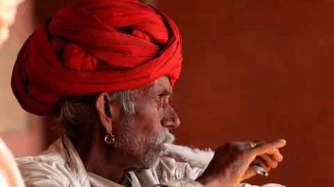 How to get AI to work in its 22 languages Getty Images A man in a red turban smokes a cigarette