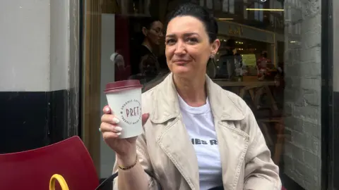 How coffee chains like Costa lost the matcha generation Mimoza Emsa with dark brown hair in a ponytail wearing a beige jacket over a white t shirt sitting outside Pret holding a takeaway coffee cup