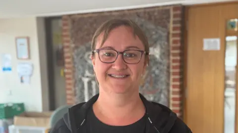 Free school uniform bank in Suffolk 'vital' say parents George King/BBC A head and shoulders image of Laura Brockwell. She is wearing glasses and looking into the camera.