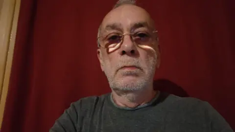Blue badge holders should not pay airport drop-off fees, charity says James Williams A medium close up of James Williams wearing a grey top and glasses