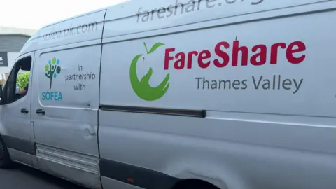 BBC The side of a large white transit van, which displays the logos of Sofea, the food charity and its supplier FareShare