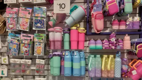Claire's was glitz 'heaven' for kids before Shein and TikTok came along Grace Dean/BBC Stickers, water bottles and tumblers on sale at Claire's