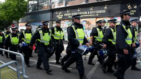 Police to deploy dedicated drone team PA Media Police officers on Ladbroke Grove during Notting Hill Carnival on 26 August 2024.