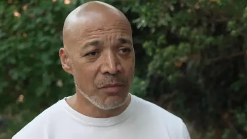 Police to deploy dedicated drone team Matthew Phillip in a white t-shirt in front of greenery.