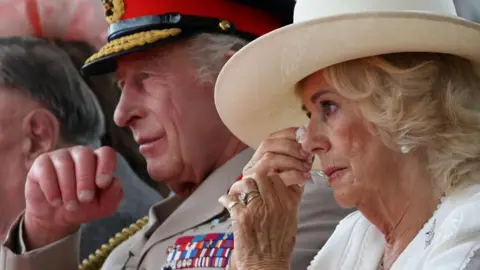 King hails veterans' courage and sacrifice PA Queen Camilla appears to wipe away a tear as Yavar Abbas recounted his recovery from cancer