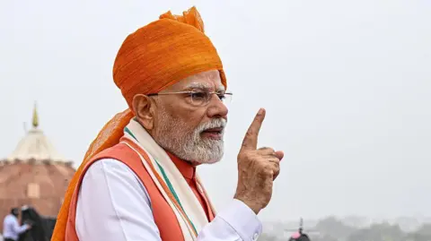 PM Modi says make and spend in India as 50% tariffs kick in Bloomberg via Getty Images Narendra Modi, India's prime minister, wearing a bright saffron turban, points to crowds during the nation's Independence Day ceremony at Red Fort in New Delhi, India, on Friday, 15 August, 2025.