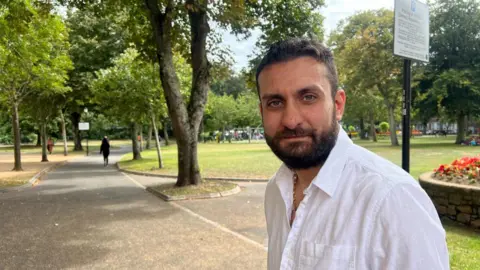Falling birth rate in Jersey a 'ticking bomb' Bobby Yordanov is wearing a white shirt, he has a dark brown beard and dark brown hair.