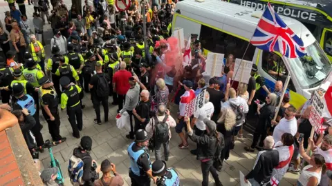 Asylum hotel protesters met by counter-demonstrators in UK Protesters and counter-protesters over the use of hotels for housing asylum seekers are kept apart by police in Bristol on 23 August 2025.