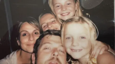 Lives torn apart by fatal crashes on the A9, Scotland's longest road Chris Strong A family photo of the Bastion-Strong family showing Chris and Katie with their three daughters. The family are all close together and smiling as they pose for the picture.