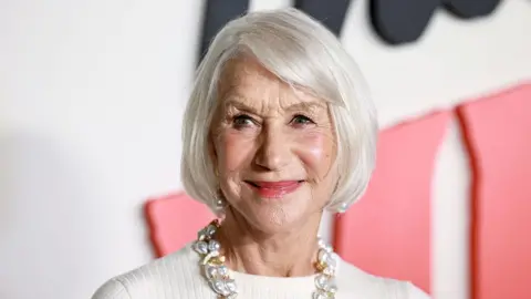 James Bond should be a man, says Dame Helen Mirren Getty Images An older woman with white hair cut in a chin-length bob is looking to the right of the camera. She is wearing pearl earrings and a chunky gold and pearl necklace, with a high necked white top.