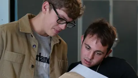What are they and how are they graded? PA Media Students at a school in Norfolk look at their A-level results
