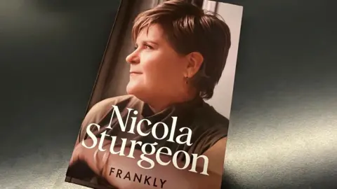 BBC A copy of a book with Nicola Sturgeon in side profile. The words Nicola Sturgeon are in white letters, with Frankly written beneath her name