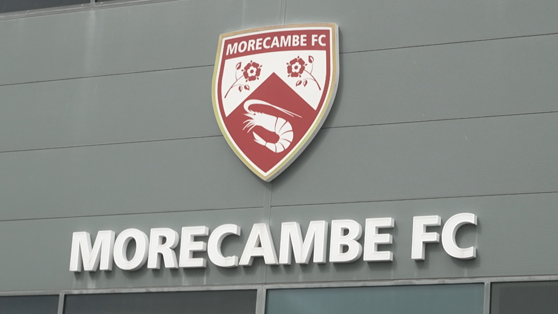 Morecambe takeover: Inside story of Panjab Warriors' first days as owners The Morecambe FC club badge and name sit on the exterior wall of the Mazuma Mobile Stadium