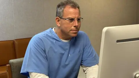 Erik Menendez denied parole in LA decades after killing parents California Department of Corrections and Rehabilitation Erik Menendez is seen in a blue prison jumpsuit sitting in front of a computer where he appeared virtually for his parole hearing.