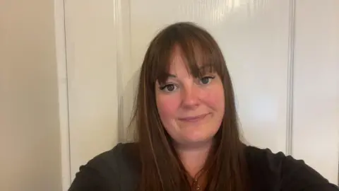 Car finance judgement 'a hard pill to swallow' Jemma Caffrey Jemma stands in a hallway looking into the camera. She has brown hair and a black top.