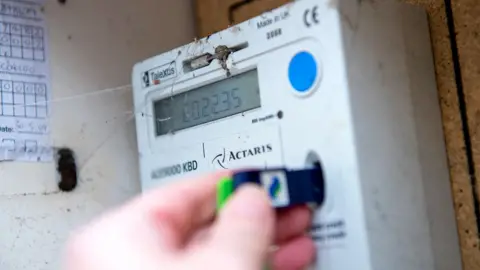 Tamworth cafe owner feared £24k E.On energy bill would sink firm Reuters Close up of a hand inserting a card into a prepayment energy meter. We an see there is a number on the screen.