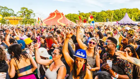 Northamptonshire's Shambala Festival marks 25th anniversary event George Harrison A crowd of people dancing at Shambala Festival on a summer day.