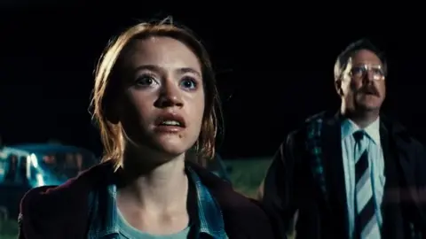 Will AI make language dubbing easy for film and TV? XYZ Films A still from the movie Watch the Skies where a young woman and a man stare into the night sky.