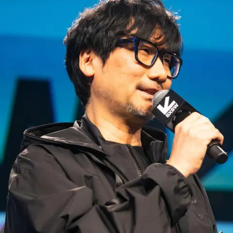 Metal Gear Solid back with remake years after Kojima left Konami Getty Images Hideo Kojima. He has black hair in a short cut and wears large black glasses. He is smiling while he talks at a conference. He is wearing a trim black jacket and black t-shirt.