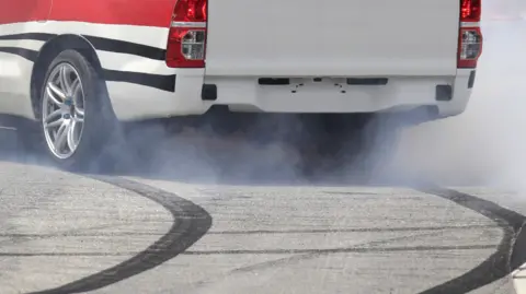 Getty Images A car leaves skid marks on a road