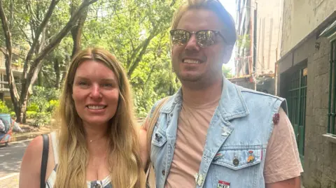 Mexicans protest tourists and gentrification American tourists Alexis and Richard Alsobrooks smile to the camera