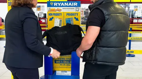 Ryanair to increase oversized bag bonus Getty Images Ryanair bag sizer at Rome Ciampino Airport, April 2025