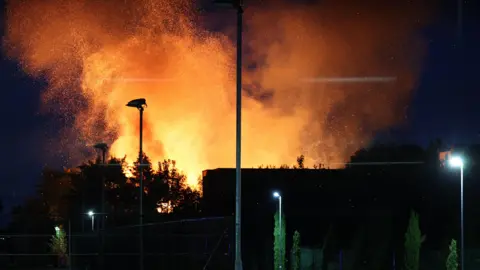 Girl, 14, arrested over fire at abandoned Woolton Hall EPA Flames rise from Woolton Hall in Liverpool, Britain, 19 August 2025.