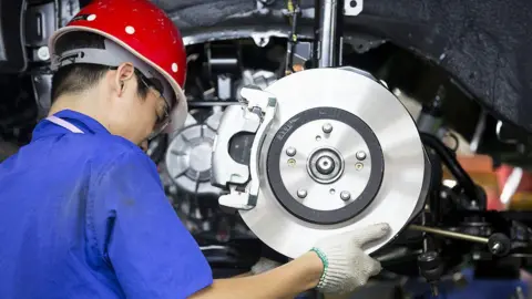 Getty Images An employee installs brake pads on new Chinese SUV in a BYD assembly plant in Shenzhen.