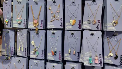 Claire's was glitz 'heaven' for kids before Shein and TikTok came along Grace Dean/BBC Rows of matching "best friends" necklaces on rails at Claire's, including butterflies, hearts and other designs