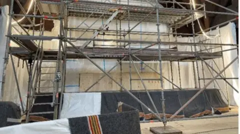 Entire church begins two-day journey across Swedish city of Kiruna LKAB Metal scaffolding securing the interior parts of the church
